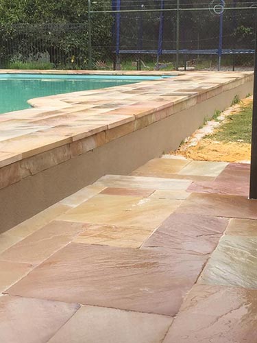 backyard-limestone-wall-around-pool